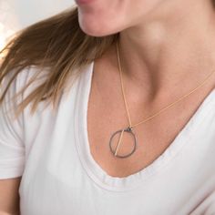 We love how the OPTIMIST necklace has a carefree, positive vibe about it!Each OPTIMIST circle starts out as a piece of sterling silver wire that we hand shape into an organic circle. It is then hammered and reshaped - no two are exactly alike! We then add a contrasting piece of hammered wire asymmetrically.Each pendant comes on our signature dainty cable chain. Necklace Details all components are sterling silver and gold filled available in 16" & 18" (recommended) chain lengths pendant measures Everyday Brass Necklace, Everyday Circular Brass Necklace, Minimalist Round Brass Chain Necklace, Everyday Wire Wrapped Necklaces, Minimalist Yellow Gold Wire Wrapped Necklace, Everyday Wire Wrapped Round Necklaces, Wire Wrapped Round Necklaces, Everyday Minimalist Hand Forged Necklaces, Minimalist Everyday Hand Forged Necklaces