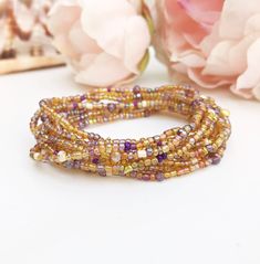 Pearl bracelet amber with rocailles | Wrap bracelet purple gold | amber colored long wrap bracelet for women made from very small Rocailles glass beads Basic colour: shiny amber-gold, with small touches of purple & lavender combined with wonderful, cut and faceted glass crystals very beautiful composition in noble colors Can be worn either individually or in combination with other wrap bracelets from my collection, which are sold separately (see photos) It looks especially beautiful when you wra Gold Wrap Bracelet With Colorful Beads, Gold Wrap Bracelet With Colorful Beads As Gift, Gold Multi-strand Wrap Bracelet For Gift, Gold Wrap Bracelet With Spacer Beads As Gift, Gold Multi-strand Spiritual Bracelet, Spiritual Gold Multi-strand Bracelets, Gold Spiritual Wrap Bracelet With Colorful Beads, Spiritual Gold Wrap Bracelet With Colorful Beads, Bohemian Crystal Bracelet With Gold Beads For Gift