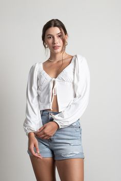 Looking for the More Of This Tie Front Top in Ivory? Shop our latest women’s White Blouses at Tobi! Get a chic look with the More Of This Ivory Tie Front Top. This crop top features an adjustable front tie closure, a front slit, and long sleeves. Bonus: the polyester and spandex material is so soft it feels like you're wearing a cloud. #shoptobi Cotton Tie Front Top, Tie Front Top Outfit, Open Front Top, White Blouses, Bohemian Blouses, Tie Front Top, Tie Front Blouse, Chic Look, Front Tie Top