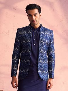 SHRESTHA By VASTRAMAY Men's Navy Blue Silk Embroidered Jodhpuri Look dapper in this classic navy blue silk Jodhpuri set. It features a beautifully embroidered jacket with a zig-zag pattern and sequins, paired with a comfortable kurta and pants. Perfect for special occasions. Key Features Navy blue silk Jodhpuri set Embroidered jacket with zig-zag pattern and sequins Mandarin collar kurta with side pockets Full sleeves, above knee length Navy blue solid pants with elasticated waistband Specificat Blue Bandhgala With Zari Work For Diwali, Tailor-ready Blue Bandhgala For Festive Occasions, Festive Blue Bandhgala, Festive Semi-formal Sets With Zari Work, Blue Nehru Jacket With Zari Work For Festive, Festive Blue Nehru Jacket With Zari Work, Formal Blue Sets With Zari Work, Formal Blue Embroidered Bandhgala, Blue Formal Sets With Zari Work