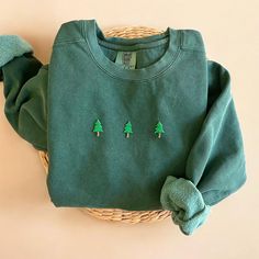 Cozy up with our Comfort Colors Christmas Trees Sweatshirt this winter season! The perfect gift for any Christmas Trees and Christmas season lovers out there! - Our sweatshirt material is super soft and high quality! ♡ - Garment-Dyed Sweatshirt (Sustainable style)  - 80% cotton, 20% polyester - All our sweatshirts run a UNISEX fit. (Both for men and women) They fit true to size. But if you like a more baggy look, we highly recommend sizing up. - These letters are embroidered iron-on patches that Christmas Cotton Long Sleeve Sweater, Casual Cotton Christmas Sweatshirt, Casual Christmas Cotton Sweatshirt, Casual Christmas Sweater With Relaxed Fit, Casual Christmas Crew Sweatshirt, Casual Christmas Crew Neck Sweatshirt, Casual Cozy Christmas Top, Green Holiday Sweatshirt For Fall, Green Fall Holiday Sweatshirt