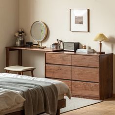 a bedroom scene with focus on the bed and dresser in the foreground as well