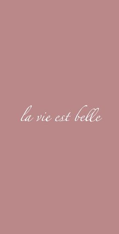 the words la vie est belle written in white on a pink background