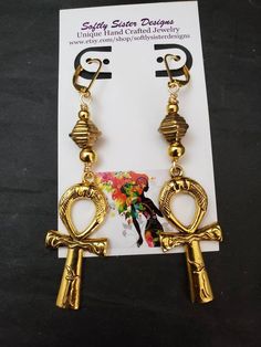 "Beautiful handmade earrings made with high quality gold plated metal Ankh symbol, and nickel free gold plated leverback earwires. Lightweight and easy to wear, these earrings are 3\" long. Please come back and visit to check for more unique new designs and styles For more styles visit my Etsy shop:www.etsy.com/shop/SoftlySisterDesigns" Nickel-free Ankh Gold Earrings, Gold Ankh Metal Jewelry, Gold Ankh Shaped Metal Jewelry, Ankh-shaped Metal Earrings For Gift, Ankh Shaped Metal Earrings For Gift, Gold Dangle Copper Earrings, Adjustable Gold Plug Earrings With Ear Wire, Gold Copper Dangle Earrings, Nickel-free Gold Copper Earrings