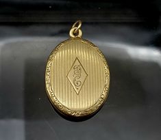 "This beautiful Vintage solid 14K Gold locket is in pristine condition. It features very fine engraving on the face centered with the scripted initials \"D\" and \"C\". The closure on this locket snaps tight and is extremely secure. This locket measures 1 1/2\" in height and 7/8\" in width and it weighs 7.3 grams. *Please note: The chain pictured in one of the thumbnails does not come with this locket." Classic Oval Locket Necklace Stamped 14k, Classic Formal Locket Necklace With Oval Pendant, Classic Locket Necklace With Polished Finish For Formal Occasions, Timeless Oval Engraved Locket Necklace, Timeless Engraved Oval Locket Necklace, Classic Polished Locket Necklace For Formal Occasions, Classic Formal Oval Pendant Locket Necklace, Timeless Engraved Locket Necklace For Formal Occasions, Classic Pendant Locket Necklace For Formal Occasions