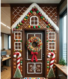 a gingerbread house decorated for christmas with candy and candies on the front door