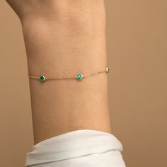 Tanya Add a touch of verdant magic to your wrist with the Emerald Station Bracelet, a celebration of the May birthstone. This enchanting piece features a chain of vibrant emeralds, catching the light like dewdrops on leaves. The gleaming gold setting complements the emeralds' natural beauty, creating a timeless and elegant design. - Handmade- Solid Gold- Natural Emerald - Total Emerald Carat Weight: 0.60 ctw- 5 Emerald Bezels: 0.12 ctw each- Size of Bezel: 5 mm All pieces come beautifully boxed in suede pouches you can always use when traveling! Green Round Chain Bracelet Gift, Emerald Bracelets For May Birthstone, Green Emerald Bracelet For May Birthstone, Elegant Green Chain Bracelet As Gift, Elegant Green Chain Bracelet Gift, 14k Gold Bracelet Jewelry For May Birthstone, Emerald Bracelet Jewelry Gift, Green 14k Gold Bracelet As A Gift, 14k Gold Bracelet For May Birthstone