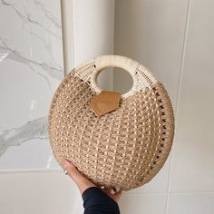 Straw rattan bags are the perfect fashion accessory to wear everywhere, anytime. This Woven Rattan Round Shaped Handbag is carefully designed and handmade by artisans from all over the world. Handwoven Rattan Vacation Bags, Bohemian Beige Straw Bag Made Of Rattan, Handheld Woven Beige Bucket Bag, Natural Woven Rattan Bag, Beige Handheld Woven Bucket Bag, Handheld Beige Woven Bucket Bag, Handheld Woven Beach Bag In Beige, Beige Woven Bucket Bag With Round Handle, Eco-friendly Palm Leaf Bag With Open Weave