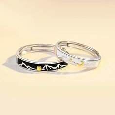 two rings with mountains and stars on them