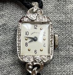 "Vintage beautiful diamond and platinum lady's watch made in the 1930s. This watch runs and keeps good time. The face measures are 15mm\"x 10mm\" rectangular.It will fit a 5 1/2\" inch wrist and it has a safety chain." Vintage Formal Watches With Single Cut Diamonds, Vintage Silver Diamond Watch With Accents, Antique Silver Diamond Watch With Accents, Art Deco Platinum Watch With Diamond Accents, Silver Art Deco Diamond Evening Watch, Antique Costume Jewelry, Blossom Jewelry, Vintage Jewelry Antique, Vintage Watches Women