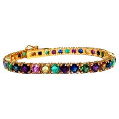 Gem Line. 17.20ct. Natural Blue/Yellow / Pink Sapphires, Green Garnet, Emerald, Ruby & Diamonds bracelet. Full round cuts, great sparkles. Clean Clarity & Transparent. (1) .35ct Natural Round Brilliant Diamond. H-color Vs-2 clarity Secure pressure clasp and safety catch. 18.4 grams. 14kt. yellow gold. Measures 7 inches (wearable length) 5.2mm wide. 37 stones $15,000 Appraisal Certificate to accompany Diamonds Bracelet, Bracelet Tennis, Gold Bracelet Set, Ruby Bracelet, Emerald Bracelet, Green Garnet, Tennis Bracelet Diamond, Ruby Diamond, Natural Sapphire