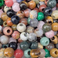 there are many different types of beads in the box together, all stacked on top of each other