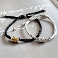 Shop our handmade minimalist braided rope couple bracelets. It can be used as personalized gift for couples, lovers, best friends, sisters or long-distance relationship. Fully adjustable rope with 925 sterling silver material makes bracelet very comfortable to wear. Mentioned price is for a pair of bracelets i.e. 1 men bracelet and 1 women's bracelet. -------- ITEM DETAILS -------- Material: 18k gold plated 925 sterling silver + high quality rope ---------- HOW TO ORDER ---------- - Please place an order first and then via Conversations please provide us engraving text in below mentioned format:  Men Bracelet Engraving on Front:  Women Bracelet Engraving on Front:  Men Bracelet Engraving on Back:  Women Bracelet Engraving Back:  - After placing an order please make sure to check Conversati Handmade Sterling Silver Braided Bracelet, Everyday Silver Braided Bracelet With Sliding Knot, Minimalist Silver Braided Bracelet For Friendship, Minimalist Silver Braided Bracelet With Adjustable Cord, Silver Minimalist Braided Bracelet With Adjustable Cord, Minimalist Silver Braided Bracelet With Sliding Knot, Silver Minimalist Braided Bracelet With Sliding Knot, Silver Sterling Braided Bracelet With Sliding Knot, Sterling Silver Braided Bracelet With Sliding Knot