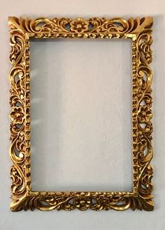 an ornate gold frame hanging on the wall