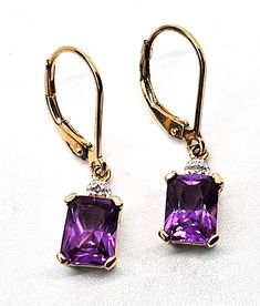 Pink Sapphire faceted open work gold over sterling silver vermeil earrings. Good used condition with little to no signs of normal vintage wear. Prong set emerald cut pink sapphire earrings. Stamped on the back 925 with a wave hallmark and China. Acid tests positive for sterling silver. Gemstone tested with Presidium II gemstone tester. Glows under UV light. Earrings measure 1 inch tall and 1/4 of an inch wide. Formal Emerald Cut Faceted Jewelry, Rectangular Yellow Gold Earrings With Gemstone, Classic Faceted Rectangular Jewelry, Classic Rectangular Faceted Jewelry, Elegant Emerald Cut Purple Jewelry, Elegant Purple Emerald Cut Jewelry, Fine Jewelry Octagon Earrings With Prong Setting, Costume Jewelry Yellow Gold Earrings For Gift, Yellow Gold Costume Jewelry Earrings For Gift