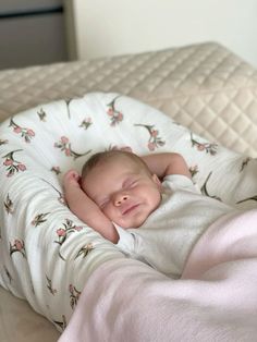 a baby is sleeping in a white blanket