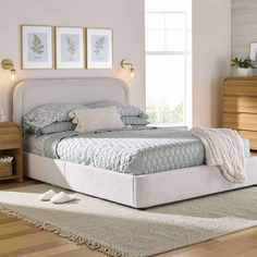 a white bed sitting on top of a wooden floor