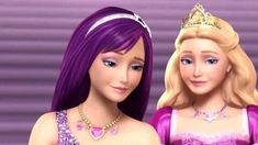 two barbie dolls wearing tiaras, one with purple hair and the other has long blonde hair