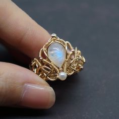 Very elaborate and ornate Victorian court ring. Made of moonstone, pearl and 14k gold filled wire.  It's a wonderful handmade craft.  Express your love and give her the best ring. It also can be a perfect gift for yourself or your friends. -------------------------- D E T A I L S * The natural stone comes from Indian * Other materials are 100% Top quality 14k gold filled from USA * Perfect for someone with sensitive skin ❤  * Each piece of jewelry is handmade with love and care ❤  * Comes in a branded gift box   -------------------------- 1 4 K  G O L D  F I L L E D  * Gold filled jewelry can last a lifetime if it is cared for properly * It is made with a thick layer of 14k gold on top of another metal, but this layer contains almost 100% more real gold than gold plated jewellery which mak Wire Crochet Jewelry, Engagement Gifts For Her, Wire Jewelry Making, Wire Jewelry Designs, Wire Wrapped Ring, Diy Wire Jewelry, Vintage Inspiration, Wire Work Jewelry, Work Jewelry