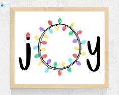 the word joy is surrounded by colorful lights on a white background with a wooden frame