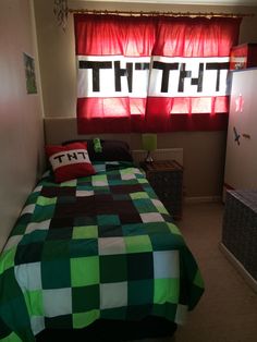 a green and black checkered bedspread on a bed in front of a window