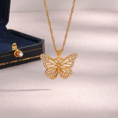 Description:Filled Hollowed-out Butterfly Chain NecklaceSpecifications:Material: cubic zirconia, stainless steel, 24k goldColors: goldSize: 40 cm + 5 cm extWeight: 6.5 g/pcs "Flutter with style with our Filled Hollowed-out Butterfly Chain Necklace. This unique necklace features a hollowed-out butterfly design that's filled with charm and elegance. A perfect accessory to complete your playful and quirky look. Get ready to spread your wings!" Butterfly Chain Necklace, Symbol Of Happiness, Butterfly Chain, Flying Flowers, Butterfly Necklace Gold, Butterfly Pendant Necklace, Waterproof Jewelry, Butterfly Necklace, Butterfly Pendant