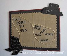 a cowboy themed bulletin board hanging on the wall