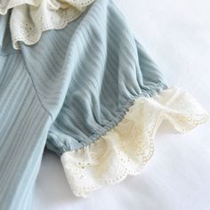 The Wavy Style Doll Original Pajamas have a cute and dainty style in light blue, with ruffles and little bows adorning the neckline. This set is perfect for hot nights to stay cool throughout your sleep thanks to its short sleeves. We are passionate about fabric and textile materials and have thus created the best, most comfortable yet practical line of pajamas. This loungewear is all you need to help relax at home. They are soft and easy to touch which projects versatility and effortless grace Dainty Style, Comfy Sets, Wavy Style, Neck Collar, Pajama Set, Round Neck, Pajamas, Cotton Fabric, Short Sleeves