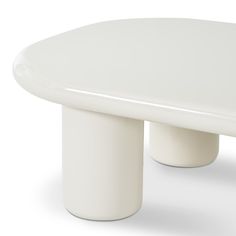 a white table sitting on top of a white floor