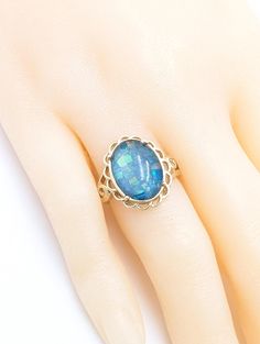 10K Opal ring. Genuine opal mosaic doublet. Size 6. Unisex. 10K solid yellow gold {not plated-not filled} Vintage estate although it has never been worn.  Condition is just as it was when made. N.O.S. It seems that I am not able to get a photo without the lights reflecting in the stone. I have posted many pictures, yet I have not captured the true beauty of this ring and it's great blue color. Cabochon measures 10mm x 14mm Collectible Gold Opal Ring With Gemstone, Gold Opal Ring With Oval Cabochon, Gold Opal Rings With Oval Cabochon, Gold Opal Ring With Oval Cabochon Birthstone, Antique Gold Opal Jewelry, Antique Opal Jewelry In Gold, Collectible Gold Opal Gemstone Ring, Oval Opal Jewelry Collectible, Collectible Oval Opal Jewelry