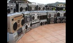 a bunch of boomboxes are stacked on top of each other