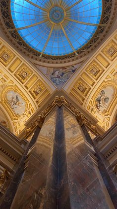 the inside of an ornate building with a blue skylight