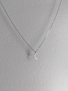 This is a delicate silver crescent moon pendant on a fine stainless steel chain. It comes in multiple lengths. It will never tarnish and is constructed from extremely high quality materials! Choose your preferred length at no extra cost! Thanks so much! Dainty Silver Moon Charm Necklaces, Dainty Silver Moon Charm Necklace, Silver Moon-shaped Clavicle Chain Charm Necklace, Silver Half Moon Charm Necklaces, Silver Dainty Moon Charm Necklace, Silver Moon Charm Necklace With Adjustable Chain, Silver Half Moon Charm Necklace, Silver Crescent Moon Phase Charm Necklace, Dainty Silver Necklace With Moon Charm