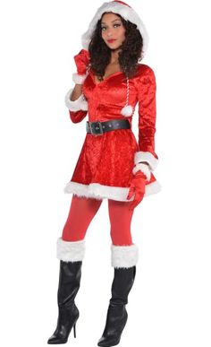 a woman dressed as santa clause posing for the camera