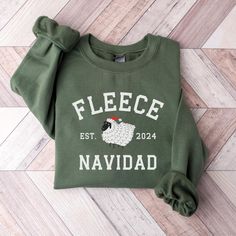 Fleece Navidad Funny Sheep Christmas Sweatshirt Baah-lieve it or not, this "Fleece Navidad" sweatshirt is the perfect blend of cozy and comical. Featuring a playful sheep design and a punny holiday twist, this sweatshirt is sure to bring laughs and warmth to the season. Crafted from soft, comfortable materials, it's ideal for lounging around the house or attending festive gatherings. Spread some woolly cheer with this unique and fun Christmas sweater.  - Unisex sizing  - Fits true to size for mo Winter Pre-shrunk Crew Neck Sweatshirt, Winter Crew Neck Pre-shrunk T-shirt, White Fleece T-shirt For Winter, Winter Fleece T-shirt With Graphic Print, Winter Fleece Crew Neck Top, Fleece Crew Neck Top For Winter, Winter Fleece Top With Crew Neck, Cozy Christmas Crew Neck Sweater, Cozy Christmas Sweater With Crew Neck