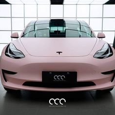 the front end of a pink sports car