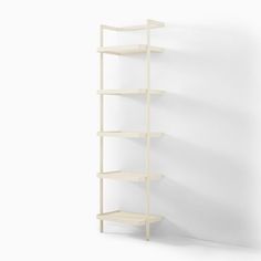 a white shelf with three shelves on each side and one is leaning against the wall