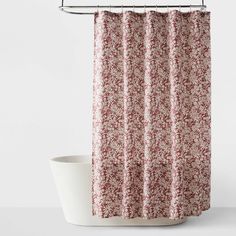 a shower curtain with a red and white floral pattern