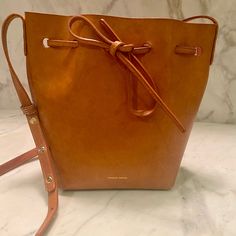 Guaranteed Authentic Mini Mansur Gavriel Bucket Bag. Leather Color Camello And Blush Interior. A Few Noticeable Marks But That’s The Beauty Of The Untreated Leather As It’s Used. 10 Inches High 7 Inches Wide 5 Inches Deep Retails For $595 Currently Blush Interior, Mansur Gavriel Mini Bucket Bag, Mansur Gavriel Bucket Bag, Mansur Gavriel Bag, Mini Bucket Bag, Mini Bucket Bags, Mini Bucket, Mansur Gavriel, Leather Bucket Bag