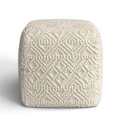 a white square shaped object with an intricate pattern on the top and bottom, sitting in front of a white background