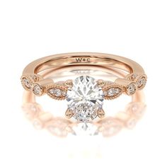 a yellow gold engagement ring with an oval cut diamond in the center and side stones