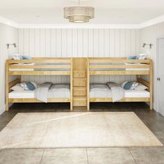 two bunk beds sitting next to each other on top of a rug in a room