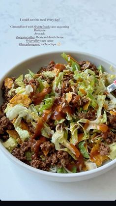 a white bowl filled with lettuce and meat