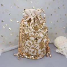 This Potli Bag goes well with both Indian and Western outfits and is superb for Wedding and Festive parties wherein it will best complement your Designer Saree, Lehnga or any other dress. Being lightweight, these bags can easily be wrapped around the wrist using their drawstrings. You can easily keep your personal belongings like Money, Mobile, Cosmetics easily in that. It can be one of the best gifts for any woman. They will just love it. Product Dimensions Length: 23cm Witdh: 12cm Product Care: Gentle Hand Wash/Closure Type: Drawstring/Outer Material: Silk, Inner Material: Other We try to take pictures as normal as we can but colors may slightly vary due to different lighting setups. Please note: No Returns No Exchange. But If you have any issue with your order, Kindly contact us before Festive Embellished Potli Bag As Gift, Elegant Festival Bags Suitable For Gifts, Elegant Festival Bags For Gifts, Elegant Festival Bags For Festive Occasions, Festive Gold Embroidery Potli Bag, Festive Embellished Bags For Festivals, Elegant Festive Bags For Festival, Elegant Festival Bags, Elegant Festival Gift Bags