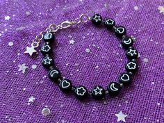 Dainty black beaded symbol bracelet! Bracelets are handmade by me! I use metal beading wire to ensure high quality, long lasting jewellery. No elastic snapping, beads popping here! The bracelet is adjustable with a clasp + extender chain and fits a 6 inch - 7 ½ inch wrist. If you would like yours to be smaller or larger, please let me know in the order note when purchasing! Bracelet comes in a little gift bag (ﾉ◕ヮ◕)ﾉ*:･ﾟ✧ Handmade Symbolic Black Bracelets, Handmade Symbolic Black Beaded Bracelets, Trendy Black Friendship Bracelets With Round Beads, Black Symbolic Bracelet Jewelry, Symbolic Black Bracelet Jewelry, Black Round Beads Bohemian Friendship Bracelets, Black Bohemian Friendship Bracelets With Round Beads, Black 8mm Beads Jewelry For Festival, Black Beaded Friendship Bracelets For Jewelry Making