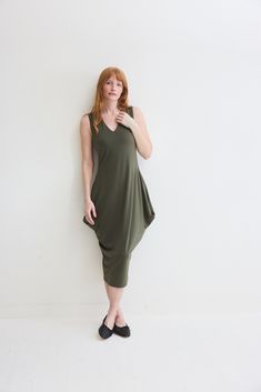 Turn heads in this chic sleeveless dress and its flattering silhouette. Pair with your favorite heels or dress down with casual sneakers. Sleeveless Tapered silhouette Midi length V-neck Modern Stretch Sleeveless Dress, Modern Sleeveless Stretch Dress, Casual Green Sleeveless V-neck Dress, Casual Stretch V-neck Summer Dress, Modern V-neck Spring Dresses, Modern Green Summer Dress, Versatile Fitted V-neck Midi Dress, Chic Green Sleeveless V-neck Dress, Versatile Knee-length Summer Dress