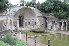 an old building with water in the middle