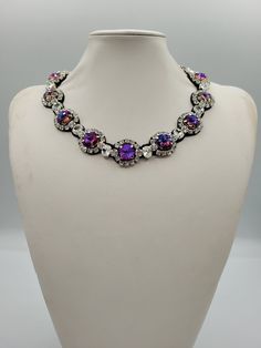 Each piece of our statement necklaces is handmade and one of a kind made in Italy. Our creations is made of high quality materials such as crystals and rhinestones. Each embroidered material is carefully hand sewn. Very glamorous and stylish. Perfect gift to someone you like. Materials Strass stones in Crystal and Violet blue color in different shape and dimension.  Black eco leather backing. Aluminium color hook closure. Measurements Weight approximate 150 grams. Circumference approximate 59 cm - 23,22 in Feel free to contact us if you have any question. Thank you so much for looking at our shop and our articles each of them, single piece. Adjustable Jeweled Crystal Necklaces, Crystal Jeweled Costume Jewelry Necklaces, Round Crystal Necklaces For Party, Crystal Necklaces For Party, Costume Jewelry Rhinestone Pendant Necklace For Party, Party Crystal Pendant Necklace With Rhinestones, Adjustable Crystal Necklace With Jewels, Unique Crystal Jewelry With Rhinestones, Party Rhinestone Pendant Necklace With Jewels