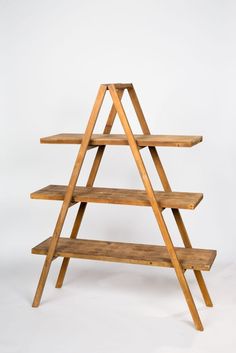 a wooden shelf with three shelves on each side and two levels to the bottom, against a white background