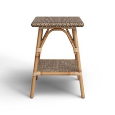 a wooden stool with wicker seat and footrests on an isolated white background